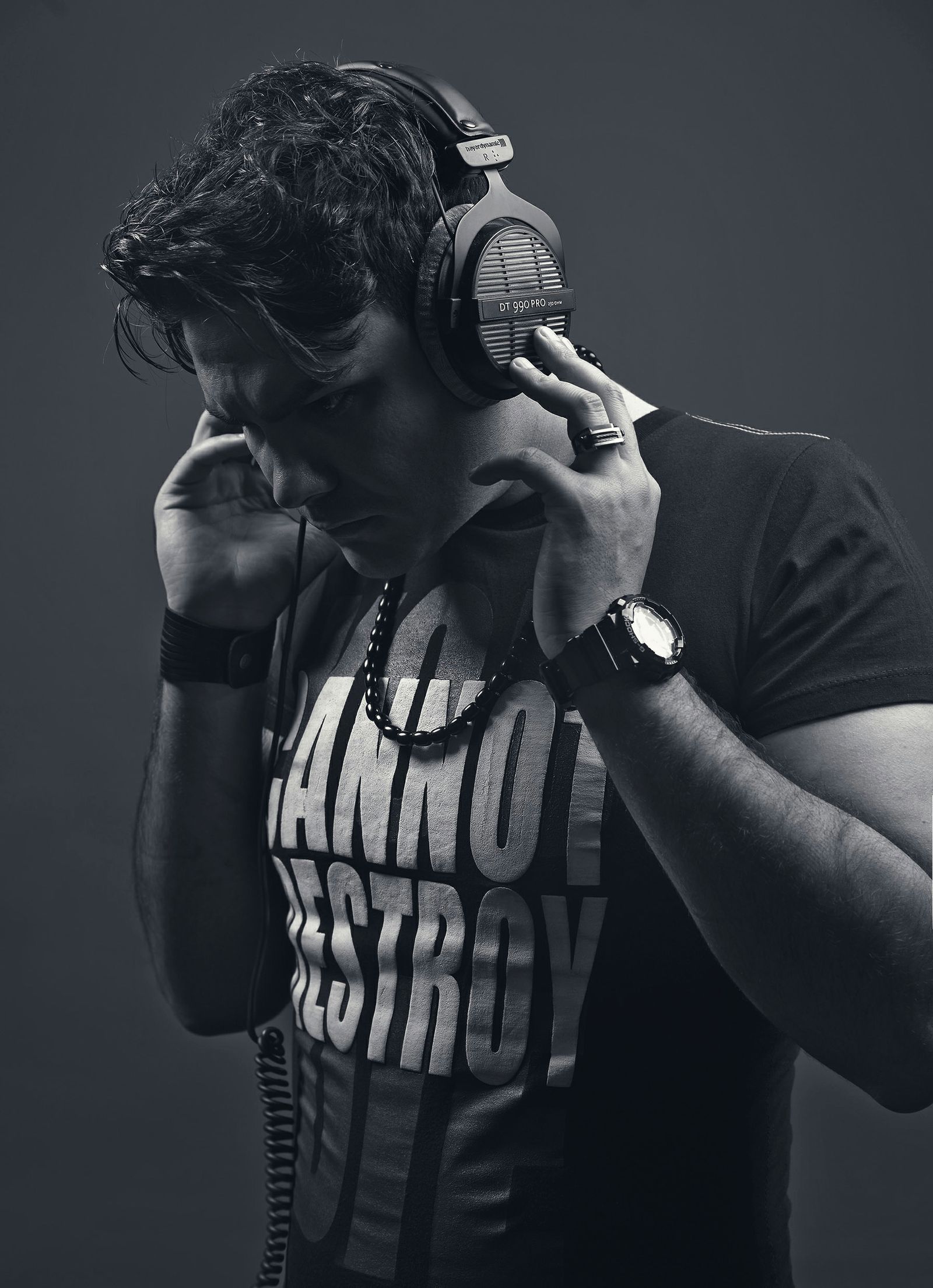 Black-and-white portrait of a man wearing headphones against a dark background