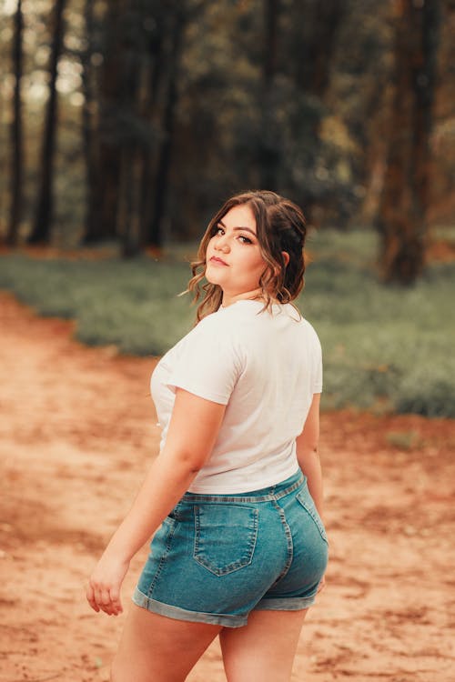 Beautiful Woman Wearing a White Shirt and Denim Shorts