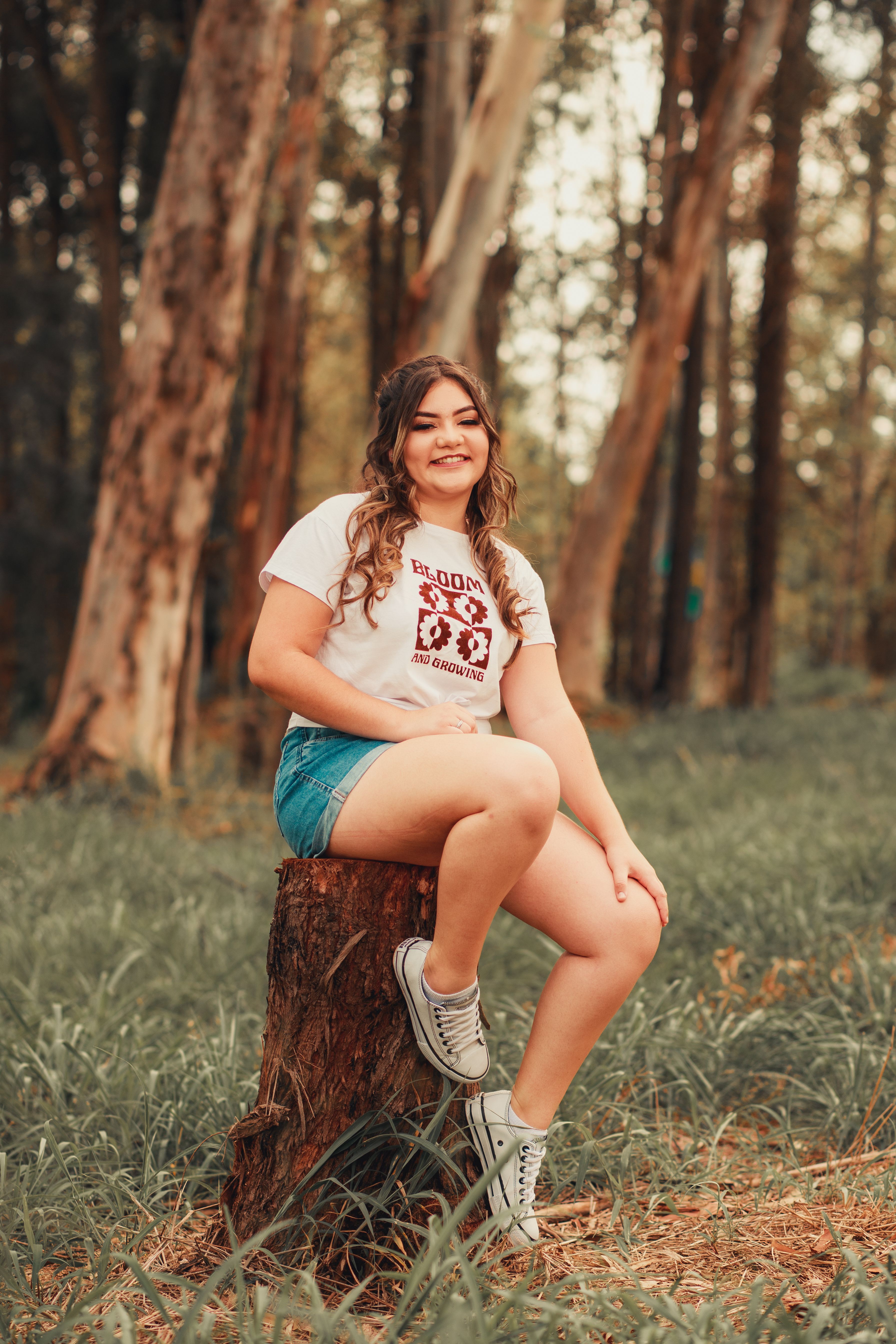 Woman in White T-shirt and Denim Shorts Sitting on a Tree Stump · Free ...