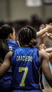 Back view of an athlete wearing jersey number 7, engaging with teammates.