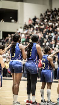 Basketball team in a sports arena ready to play in blue jerseys.