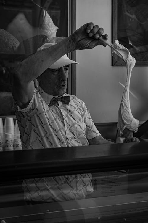 Man Putting Ice Cream in a Cone