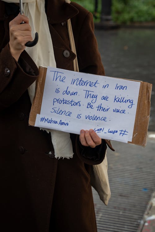 Woman Holding Placard with Handwritten Message