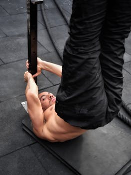 A man engages in a calisthenics exercise routine indoors, focused on fitness and strength.