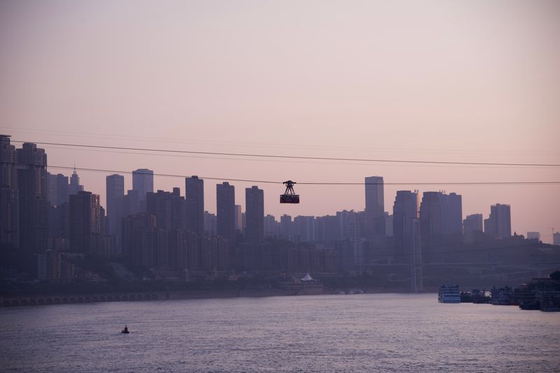 Yangtze River Cableway car crossing above Chongqing at dusk
