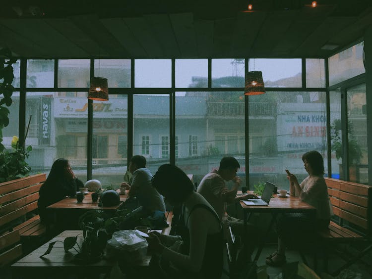 People Sitting On Chairs In A Restaurant