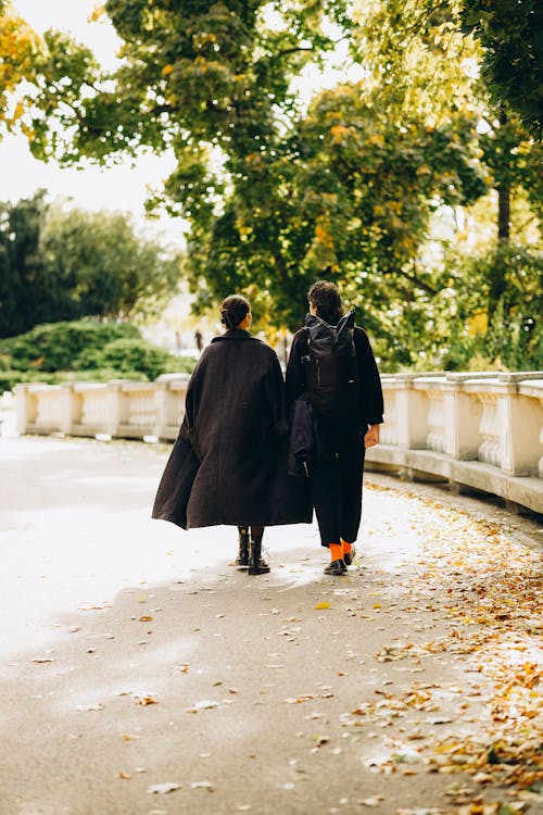 Man and Woman Walking in Park
