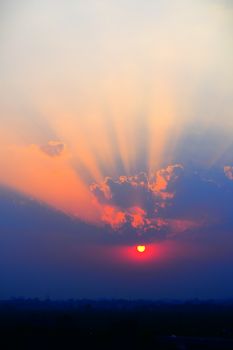 Beautiful sunset with vibrant clouds and sun rays over Ranchi skyline.