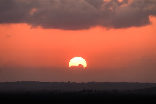 Breathtaking sunset over Paraíba, Brazil with vivid orange sky and silhouette horizon.