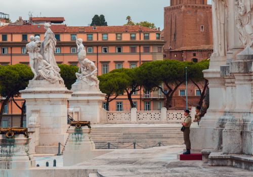Free Vittoriano Monument in Rome featuring neoclassical sculptures and security guards in a historical piazza. Stock Photo