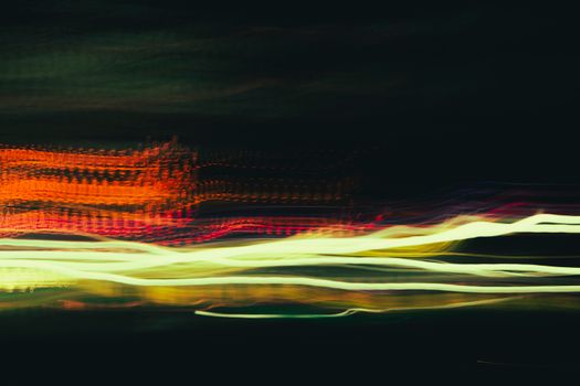 Colorful long exposure light trails create an abstract, dynamic night scene.