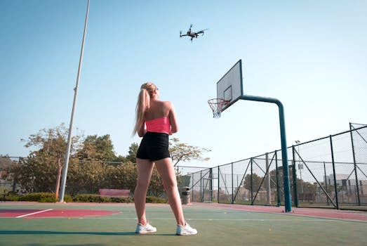 Aerial view of a woman standing on a basketball court in Dubai, United Arab Emirates.