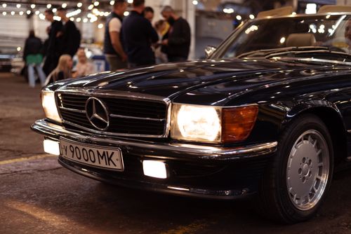 Free Close-up of a classic Mercedes Benz parked indoors, showcasing luxury and elegance at a car event. Stock Photo