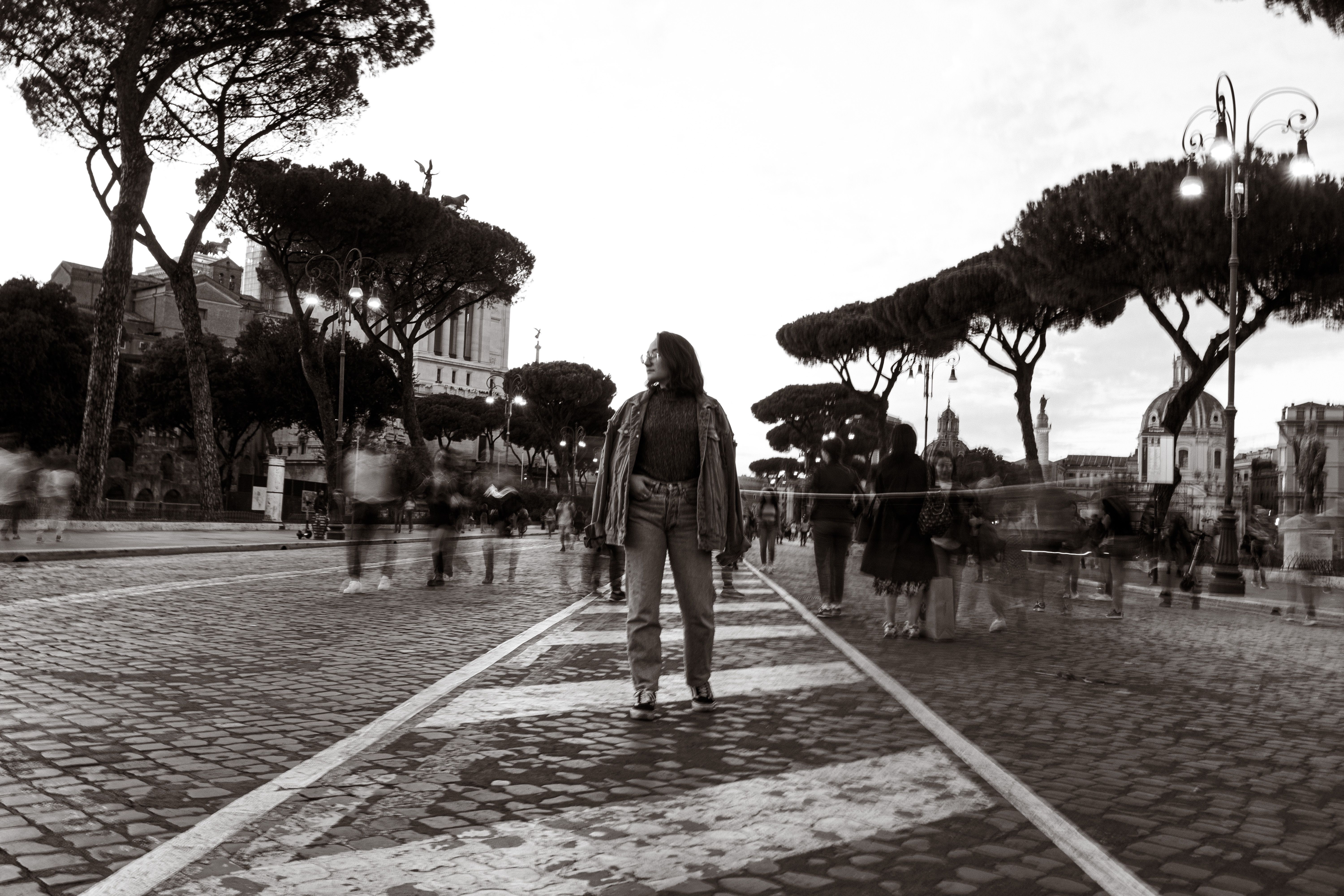 Woman Standing on a Cobblestone Street and People Passing by Her · Free ...