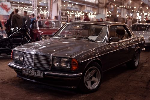 Free Vintage Mercedes Benz car displayed at an indoor classic car show with bokeh lights. Stock Photo
