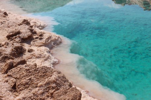 Free Stunning view of a turquoise salt lake surrounded by rocky desert terrain, a natural marvel. Stock Photo