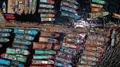 Free A stunning aerial view of colorful fishing boats docked at Penjaringan Harbor in Jakarta, Indonesia. Stock Photo