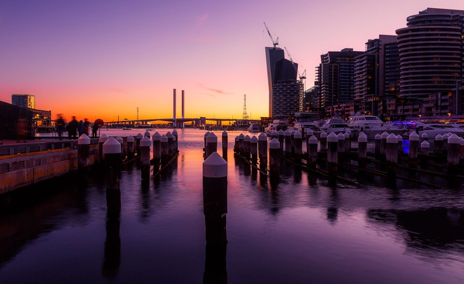 Stunning city waterfront at sunset featuring reflections and modern architecture.