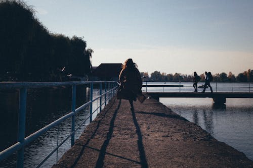 A Woman Walking on Dock