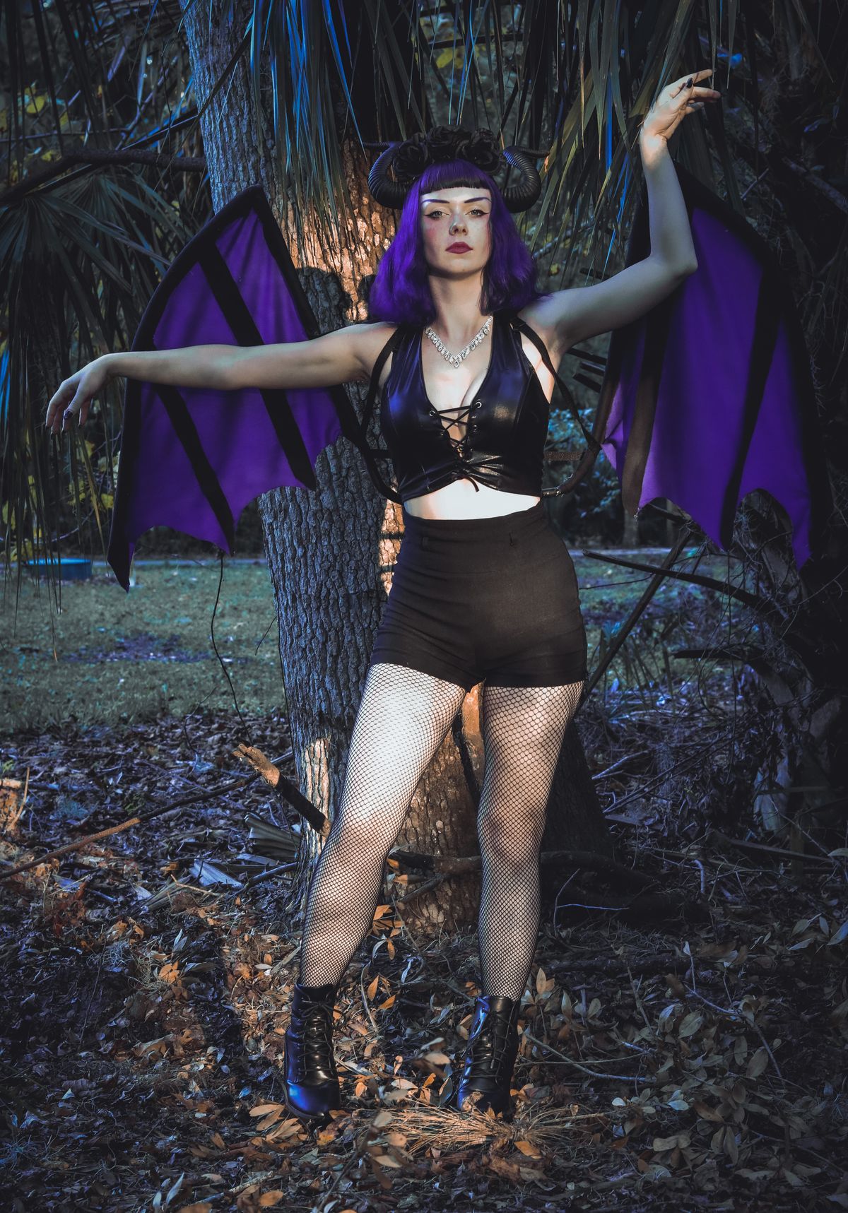 Adult woman in a bat costume in a forest for halloween costume ideas for adults