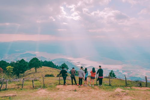 Group Of People Standing On Hill