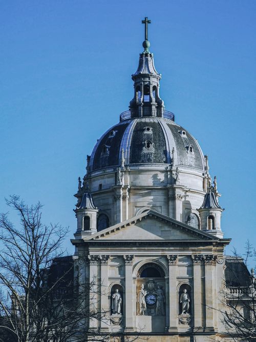 Free Elegant shot of La Sorbonne's ornate dome against a clear blue sky in Paris, France. Stock Photo