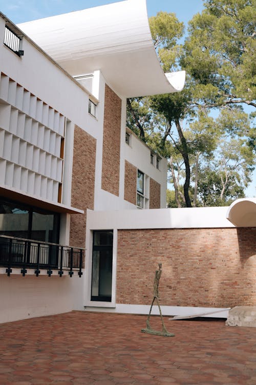 White and Brown Building Near Green Trees