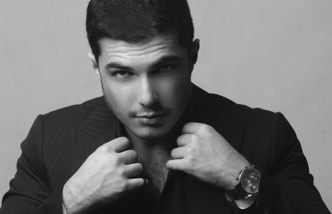 black and white portrait of a man in a stylish blazer highlighting ele