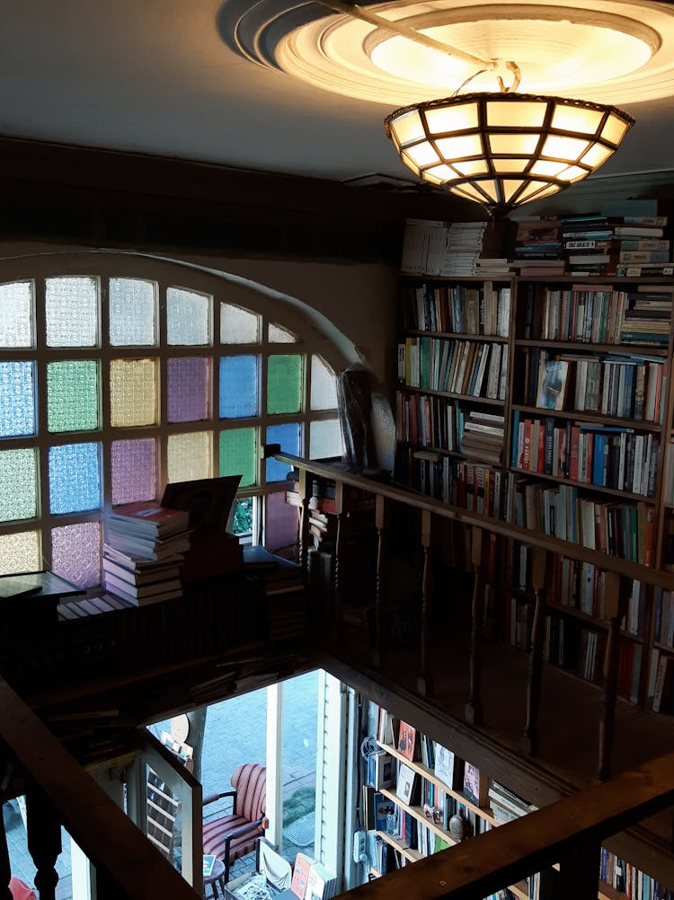 Books On Brown Wooden Shelves