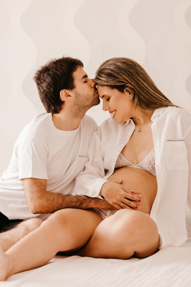 Man Kissing Pregnant Woman