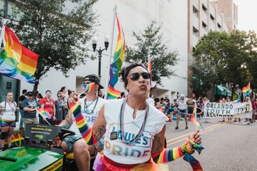 Colorful pride parade with participants celebrating diversity on city streets.