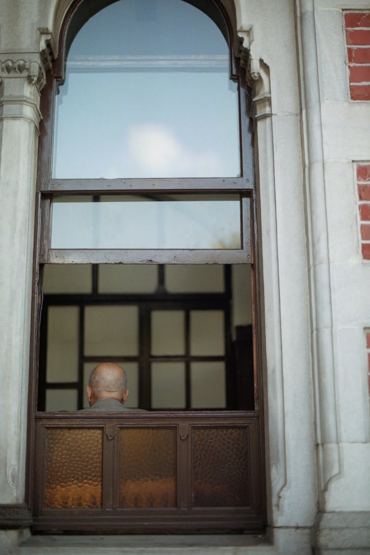 Bald Man Head Behind Window