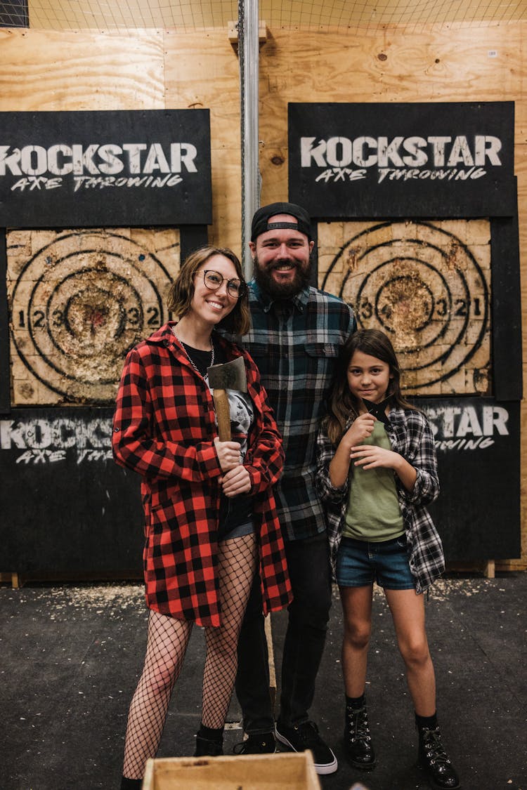 Group Of People Standing Beside Axe Throwing Targets