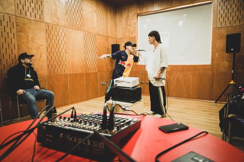 Free Two rappers engage in a dynamic battle rap session inside a professional music studio environment. Stock Photo