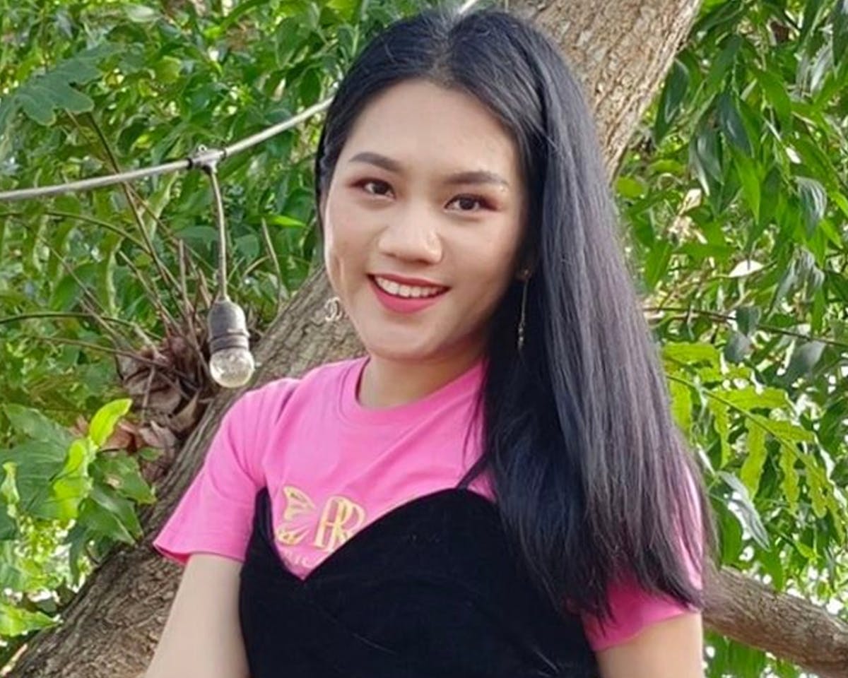 Crowd watching a race from grandstands at a circuit under clear skies