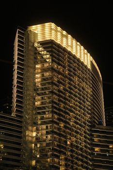 Stunning view of a luxury hotel tower with modern architecture in Las Vegas illuminated at night.