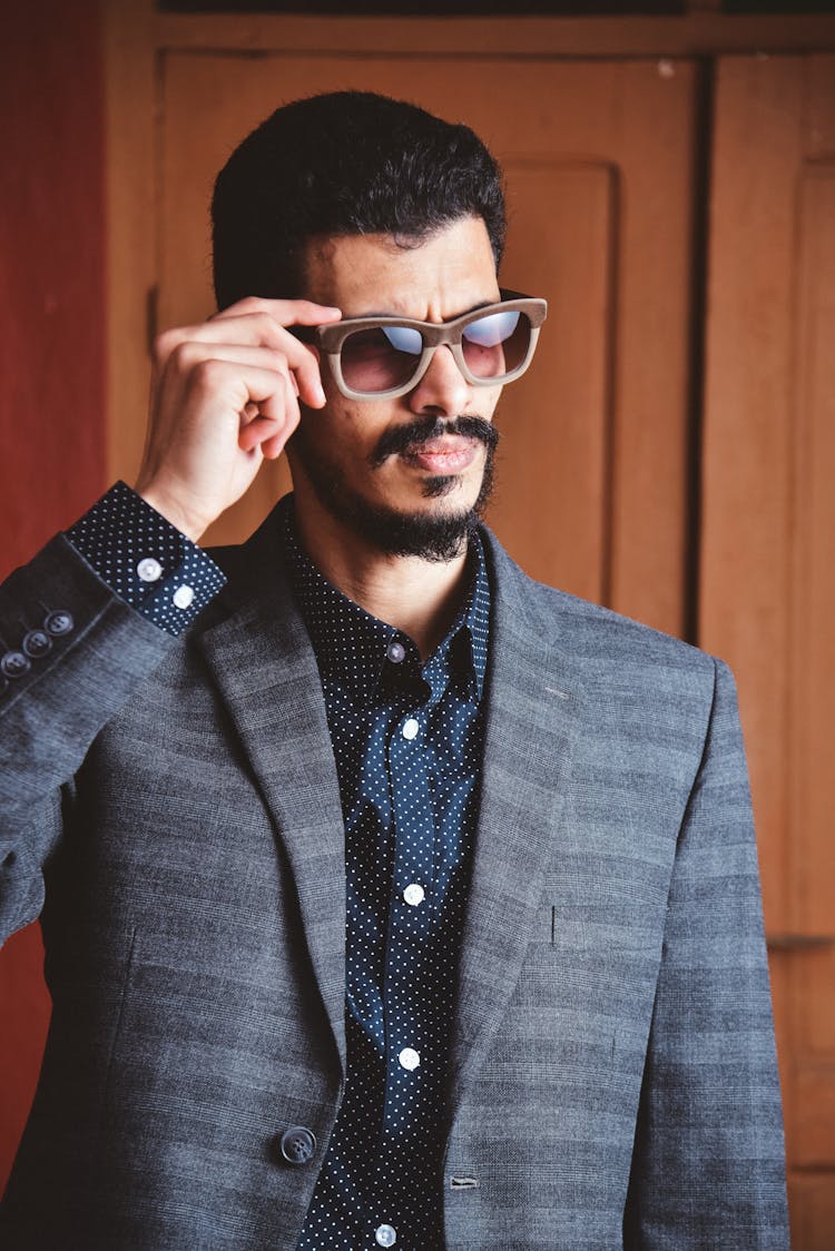 A Man In Suit And Sunglasses