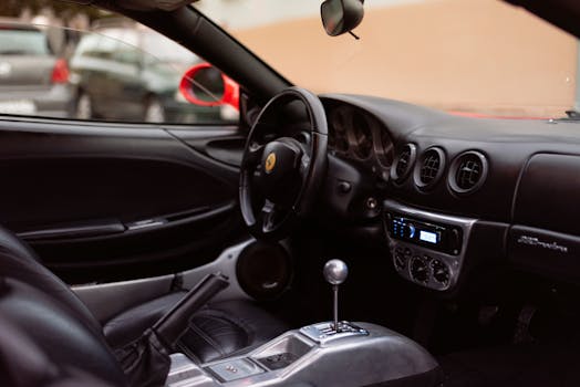 Explore the sleek interior of a luxury sports car featuring leather seats and advanced dashboard.