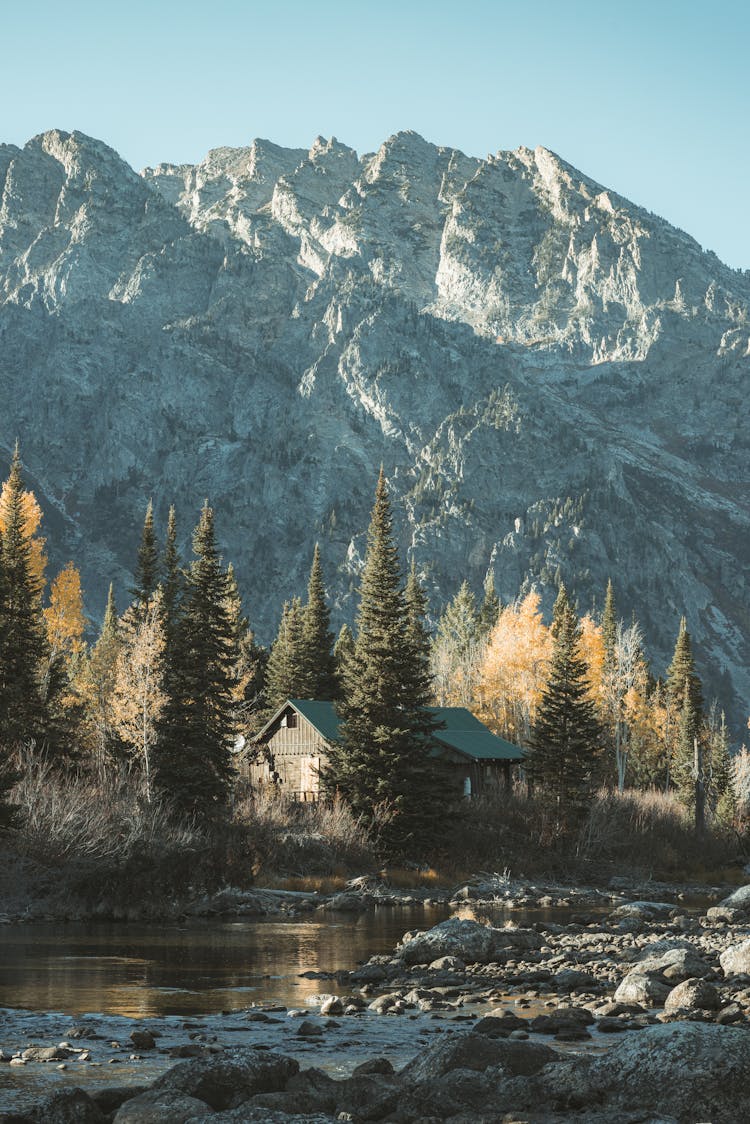 House Near Stream In Mountains