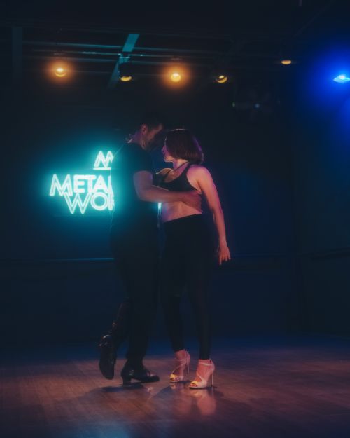 Free A couple dances intimately under soft lights, showcasing grace and connection. Stock Photo