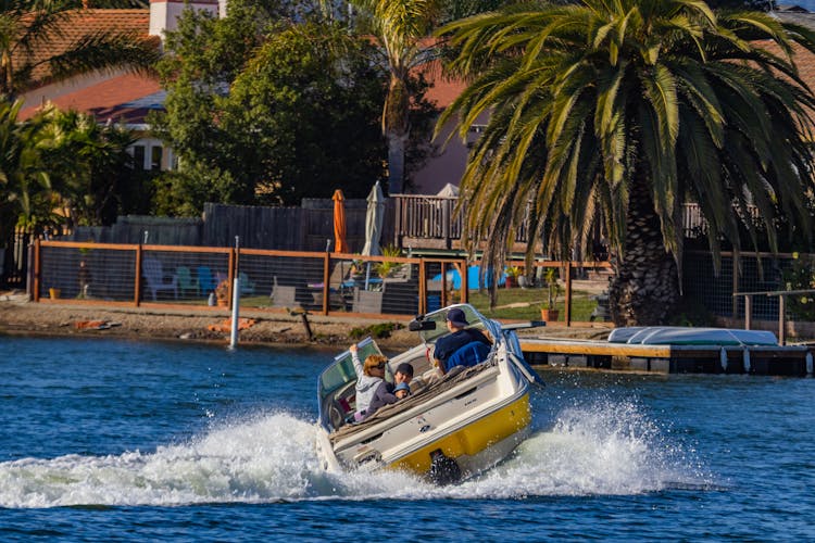 Family Riding A Speedboat In The River