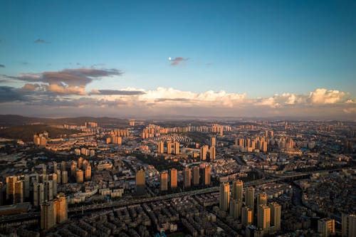 Drone Shot of a Modern City with Skyscrapers at Sunset 