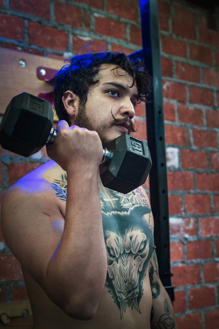 A Man Lifting A Dumbbell 