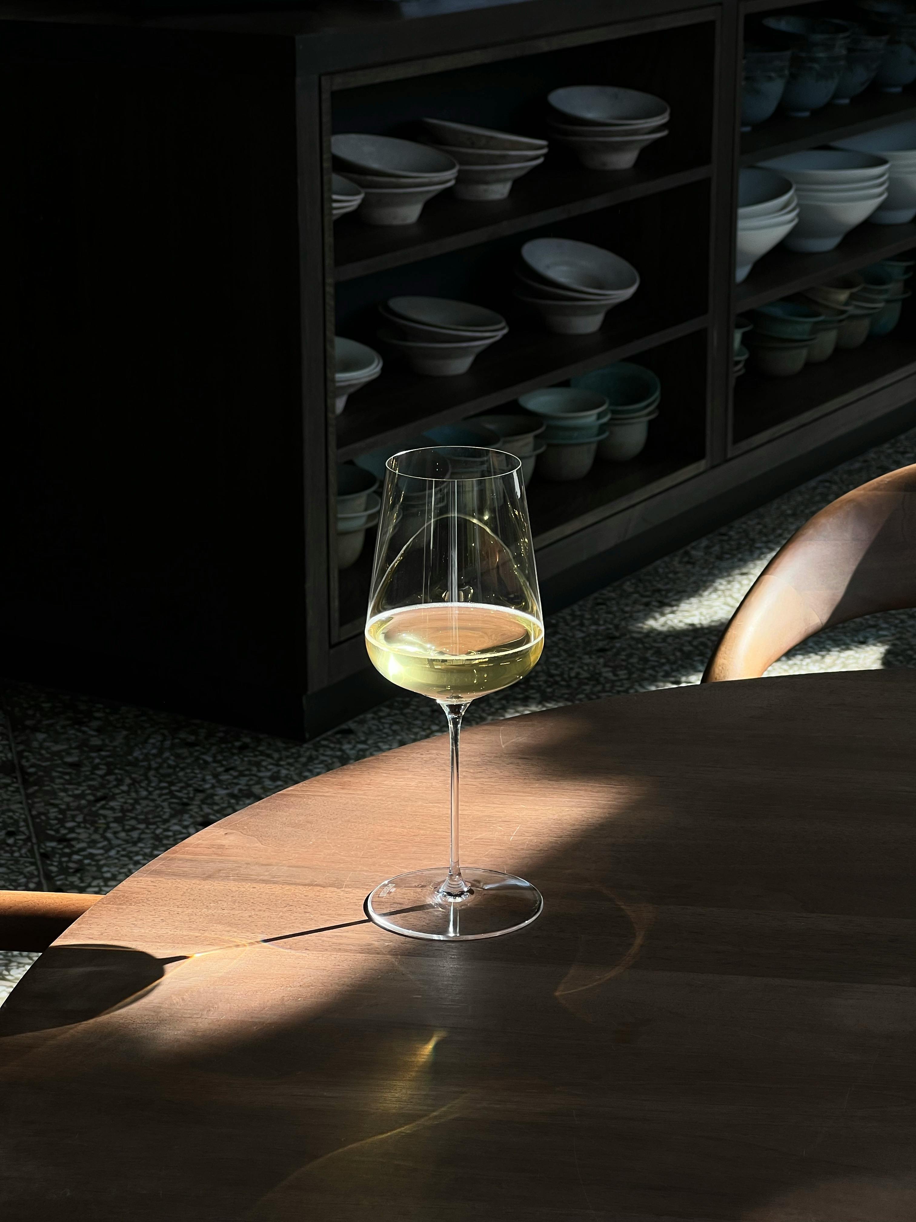 Glass with White Wine Standing on a Table · Free Stock Photo