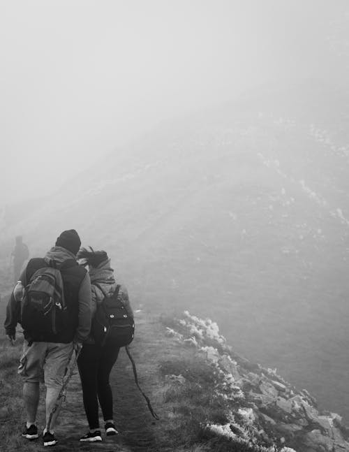 Grayscale Photo of Hikers o the Trail