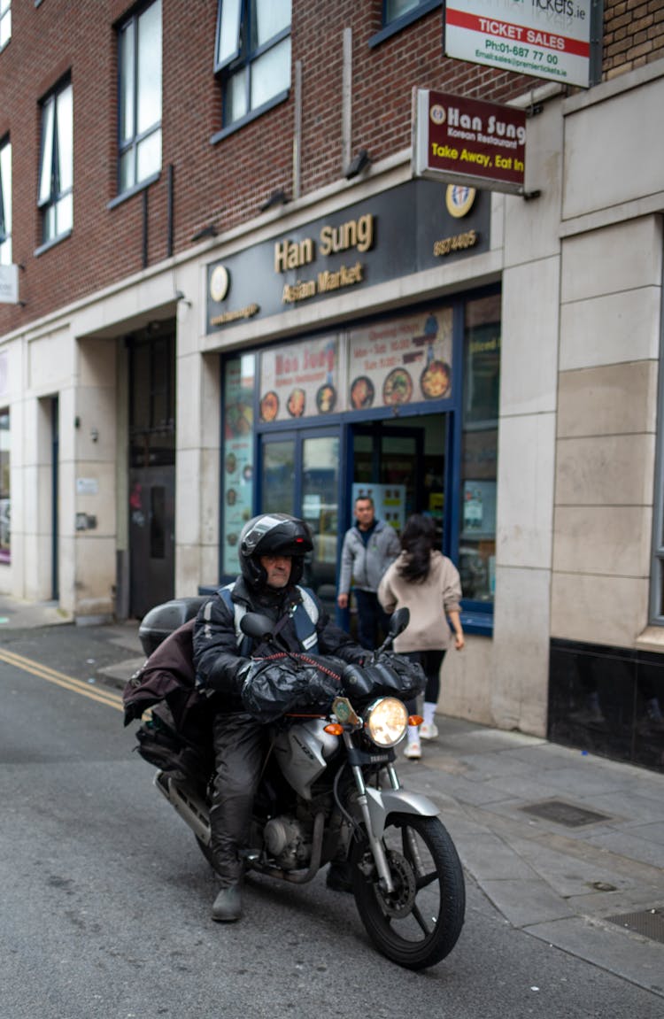 Man Riding A Motorcycle On Road