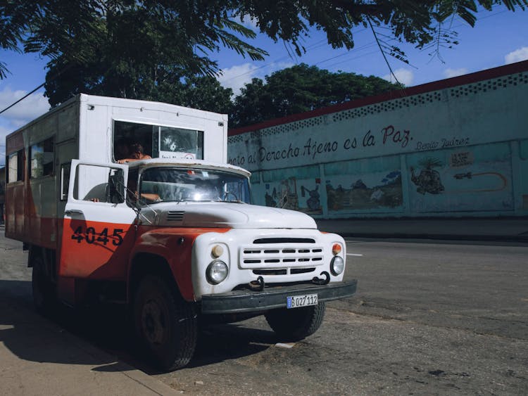 Old Truck Parked On The Side Of A Street 