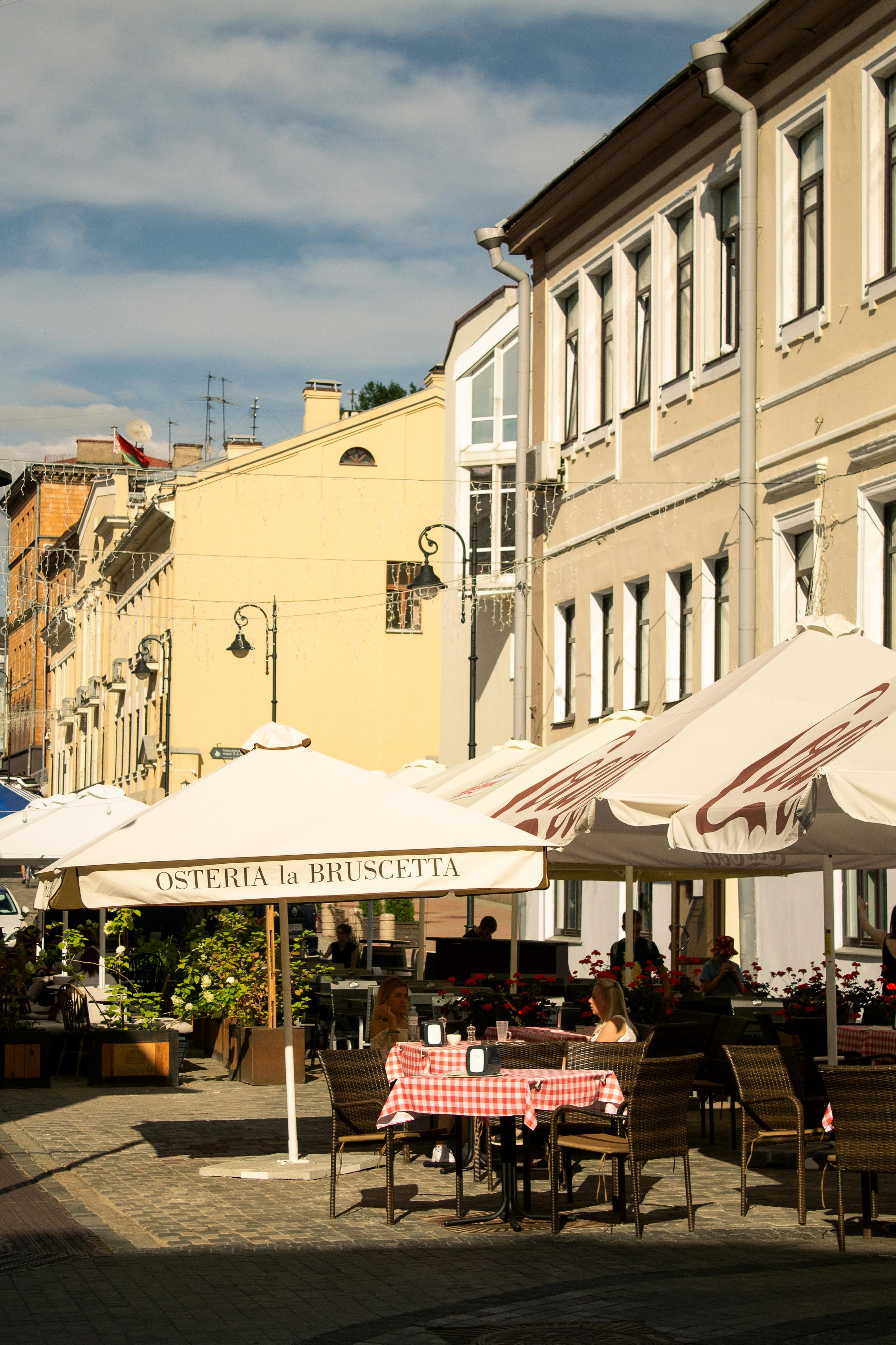 Outdoor café scene with colorful umbrellas on a Minsk street, perfect for travel and urban exploration themes.