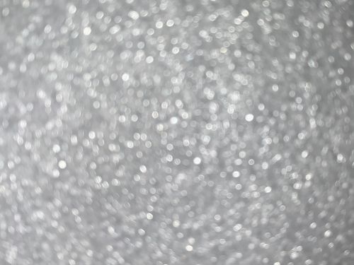 Free A soft focus abstract image featuring shimmering silver and white bokeh, perfect for backgrounds. Stock Photo