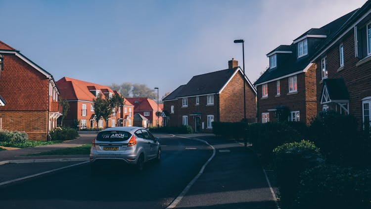 Car Running On Suburb Road